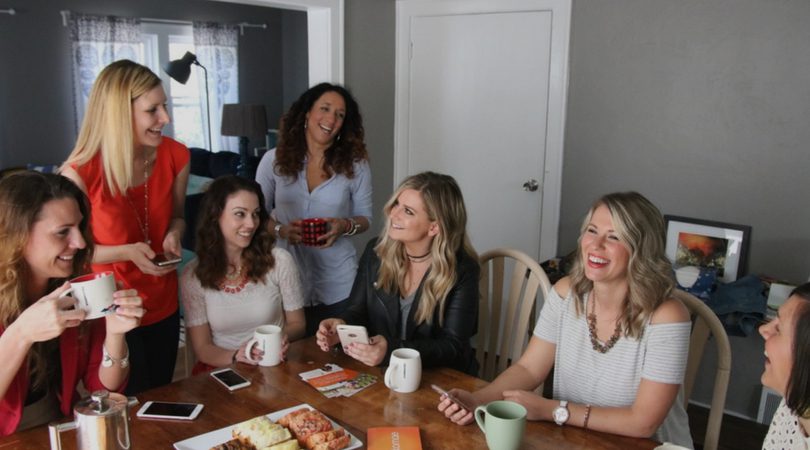 a group of women drinking coffee while talking about the Komae app