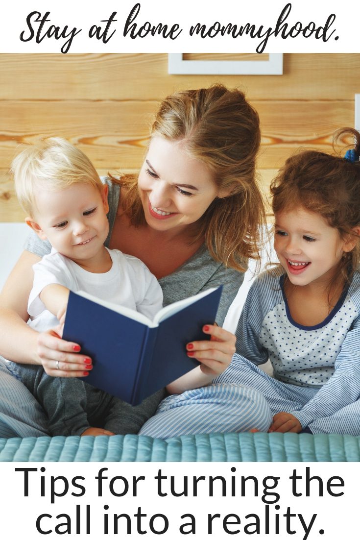 a mom reading a book to her two children, text image 'stay at home mommy hood, tips for turning the call into reality'