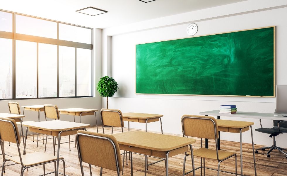 empty classroom of desks and a chalkboard