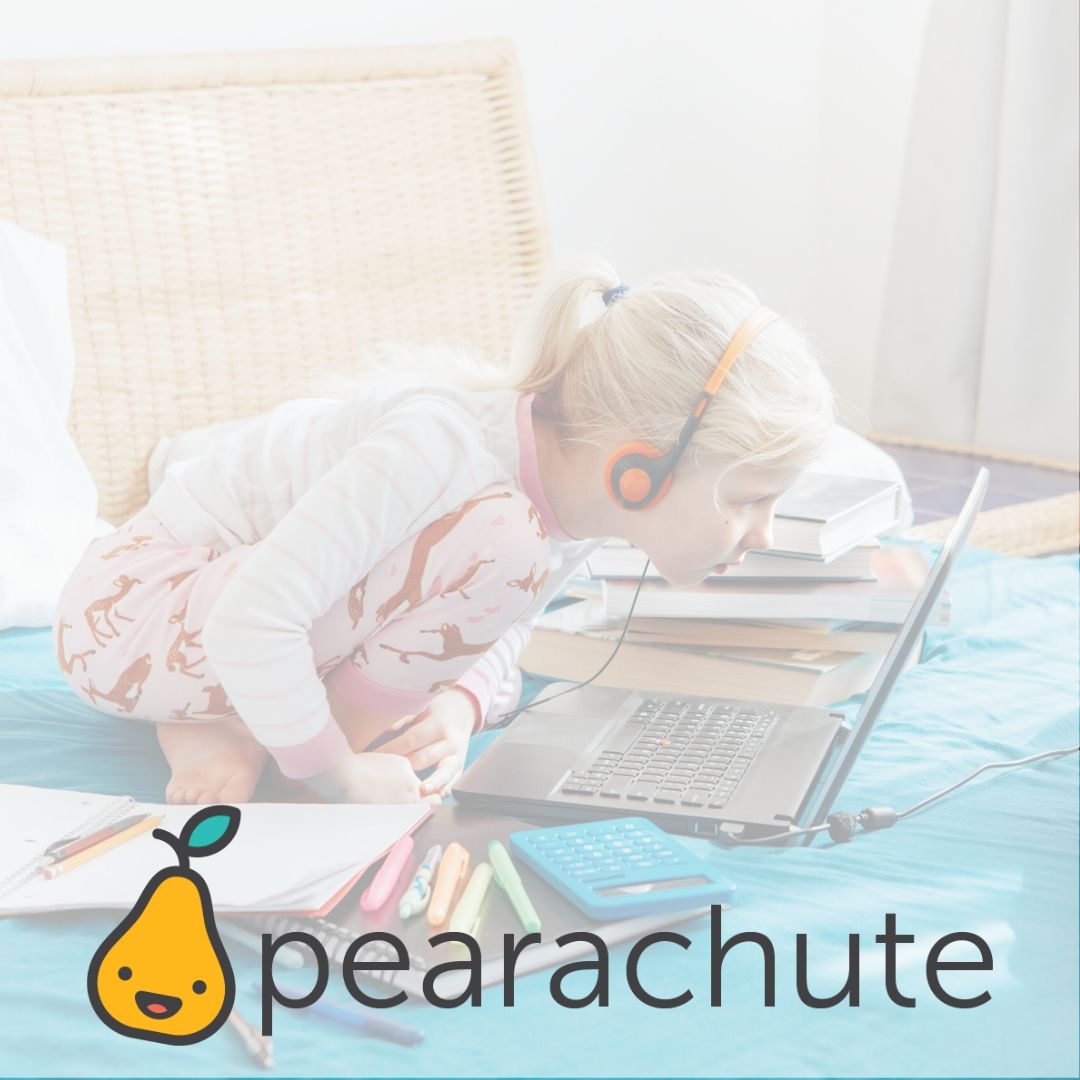 image of little girl wearing headphones watching something on her laptop doing school work