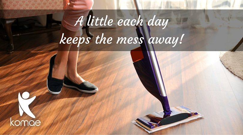 Woman mopping the floor using her cleaning chart plan.