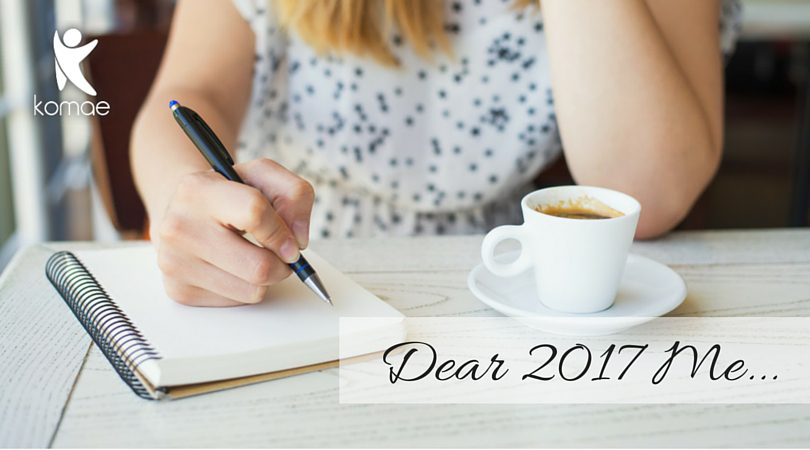 A woman journaling and drinking a coffee on new years.