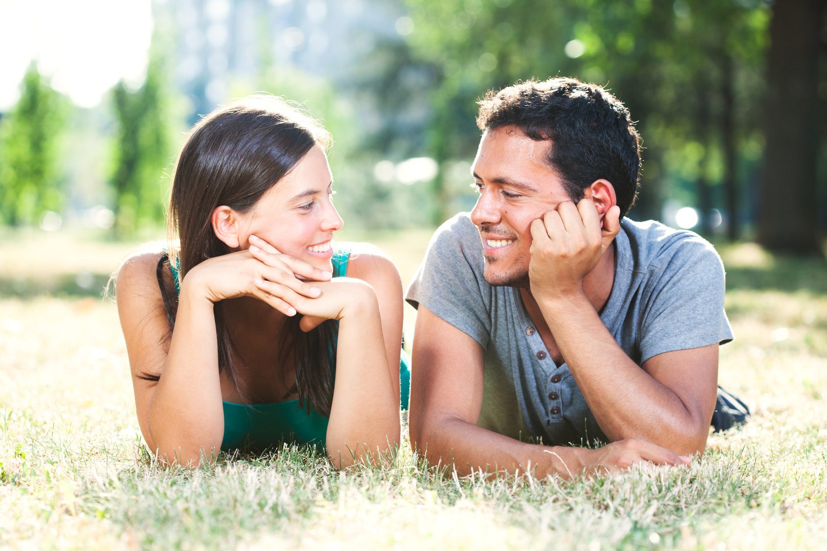 A happy couple in the park enjoying a cheap date night out!