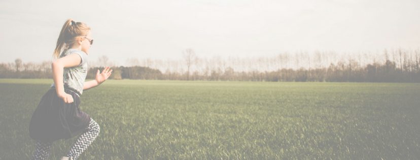 Website banner - girl running through field.